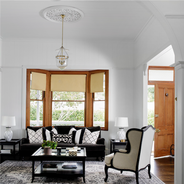 Darvall St entryway. Wooden door and window frames in a room with a black and white aesthetic