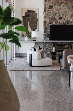 Living space with stone affect fireplace.