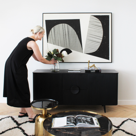 Woman styling table with flower vase